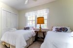 The additional guest bedroom features two twin beds and overlooks the coach house and side house garden. The very large shared bathroom is down the hall. 